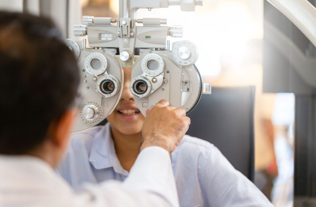 Child receiving an annual eye exam to monitor vision and check for potential hereditary eye conditions.