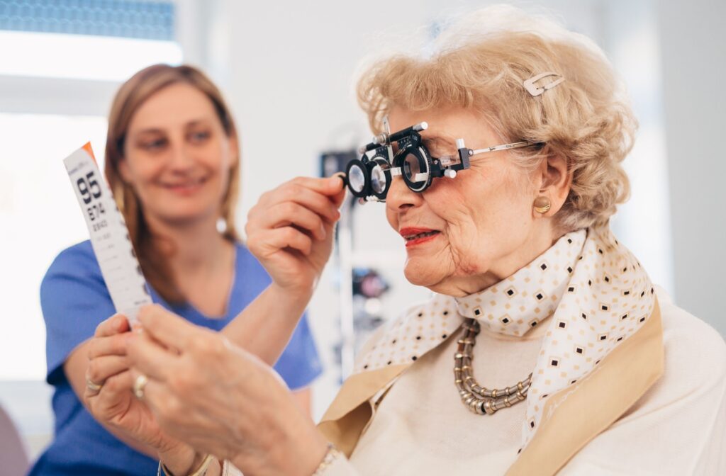 An older adult reads an eye chart to get their prescription updated.